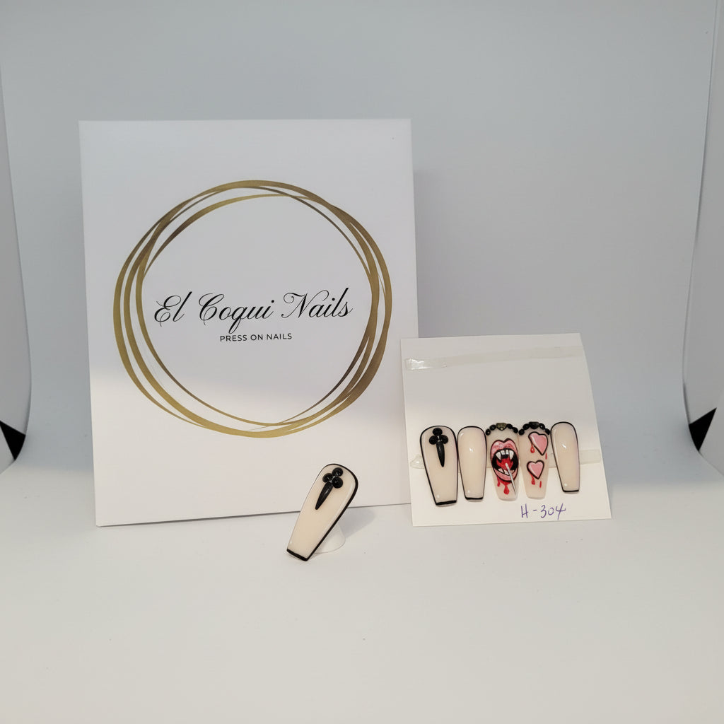 Hand made with decorated with vampire teeth holding lollipop nails holding a display of press-on nails with 'El Coqui Nails' branding.