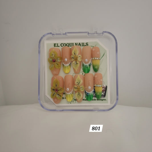 A set of 10 press-on nails in a clear plastic clamshell case, featuring peach-colored almond-shaped nails decorated with yellow flowers, green gradients, and pearl details. The brand 'EL COQUI NAILS' is visible on the insert card.