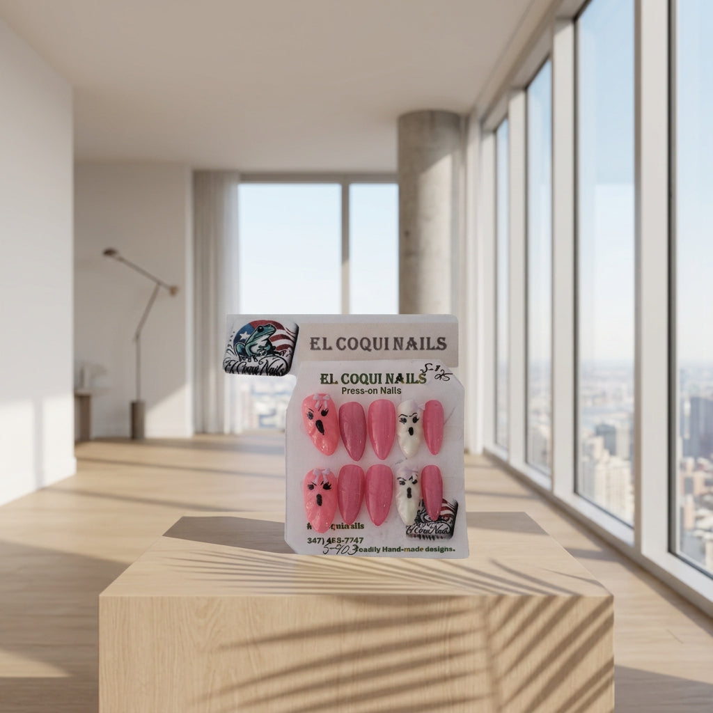 A package of El Coquins Press-on Nails featuring pink cat-eye Almond-shaped nails with black eye details, white iridescent ghost nails with black eyes, and a light green bow.