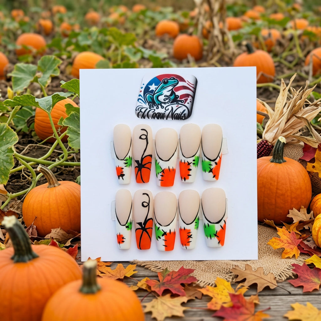 A set of 10 press-on nails by El Coqui Nails, featuring a beige base with black curved line designs and orange and green stitch patterns, displayed on its packaging card.
