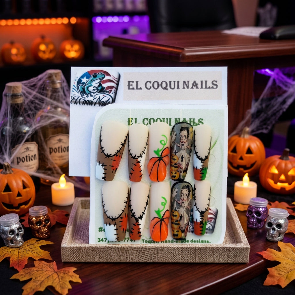 A set of Halloween-themed press-on nails by El Coquins, featuring a mix of stitched beige fingernails, orange pumpkins with green stems, and a spooky cartoon character nail. The product is displayed on its original white backing card with product codes 'M-911' and 'M-490' visible.
