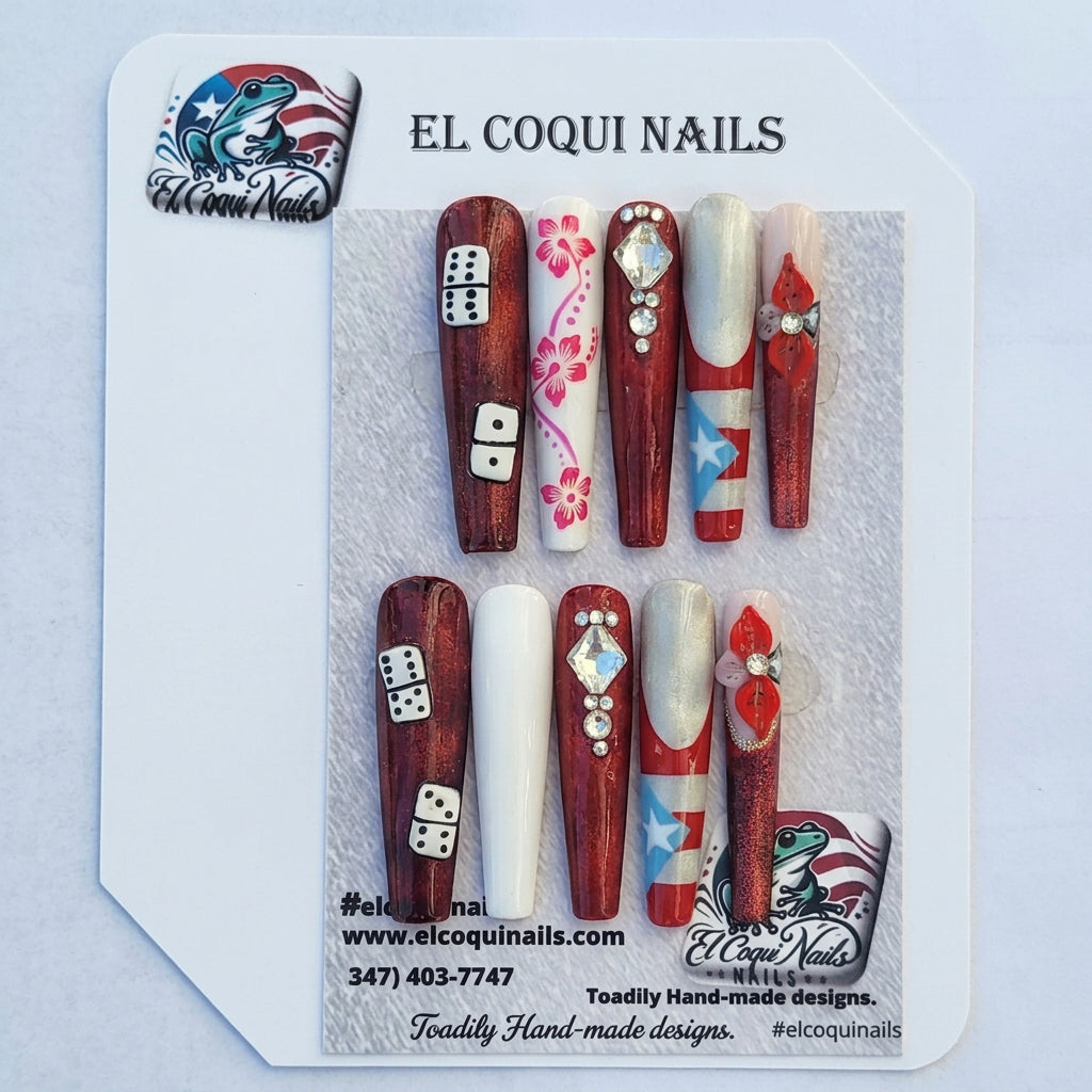 A set of 10 press-on nails displayed on a card, featuring patriotic red, white, and blue designs with stars, stripes, dice, and floral patterns. The brand 'El Coquinails' is visible on the packaging and sticker.