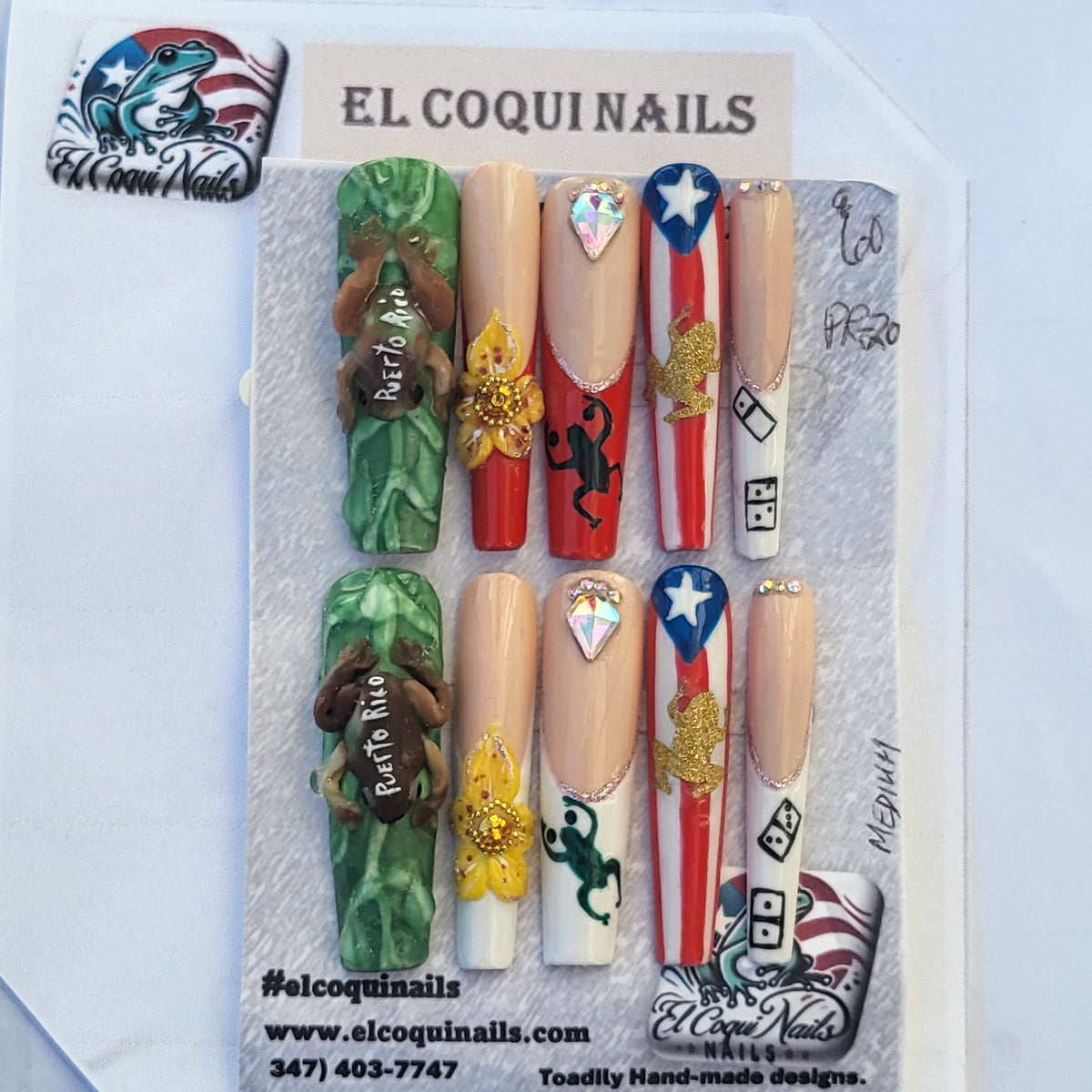A set of 10 custom decorative press-on nails displayed on a gray card under the brand name 'EL COQUINAILS'. The nails feature patriotic designs including the American flag, camouflage patterns, gold glitter, and rhinestones.